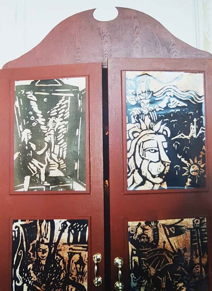 A close up of the panels of the wardrobe with the linocut illustrations.
